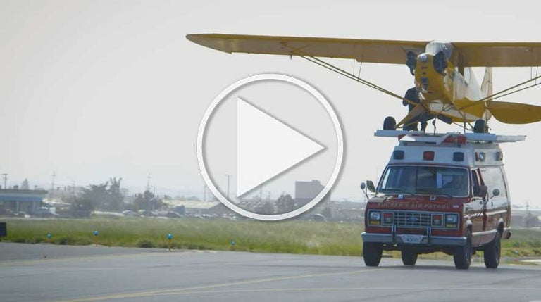 Wow! J-3 Piper Cub Lands On A Moving Ambulance