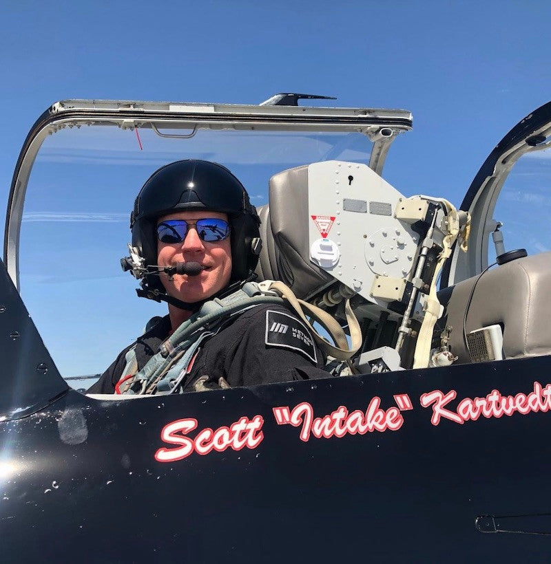 Pilot Scott Intake Kartvedt wearing Method Seven Patriot sunglasses while he sits in the cockpit of an L-39 jet aircraft.